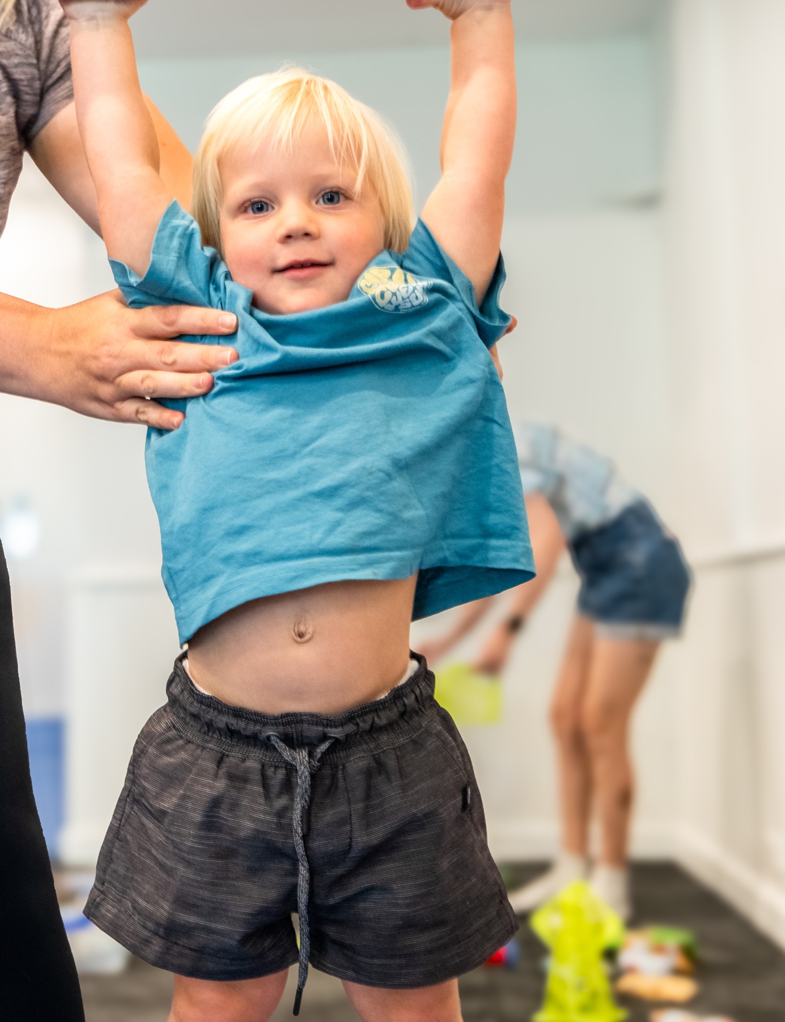 A joyful toddler with arms raised